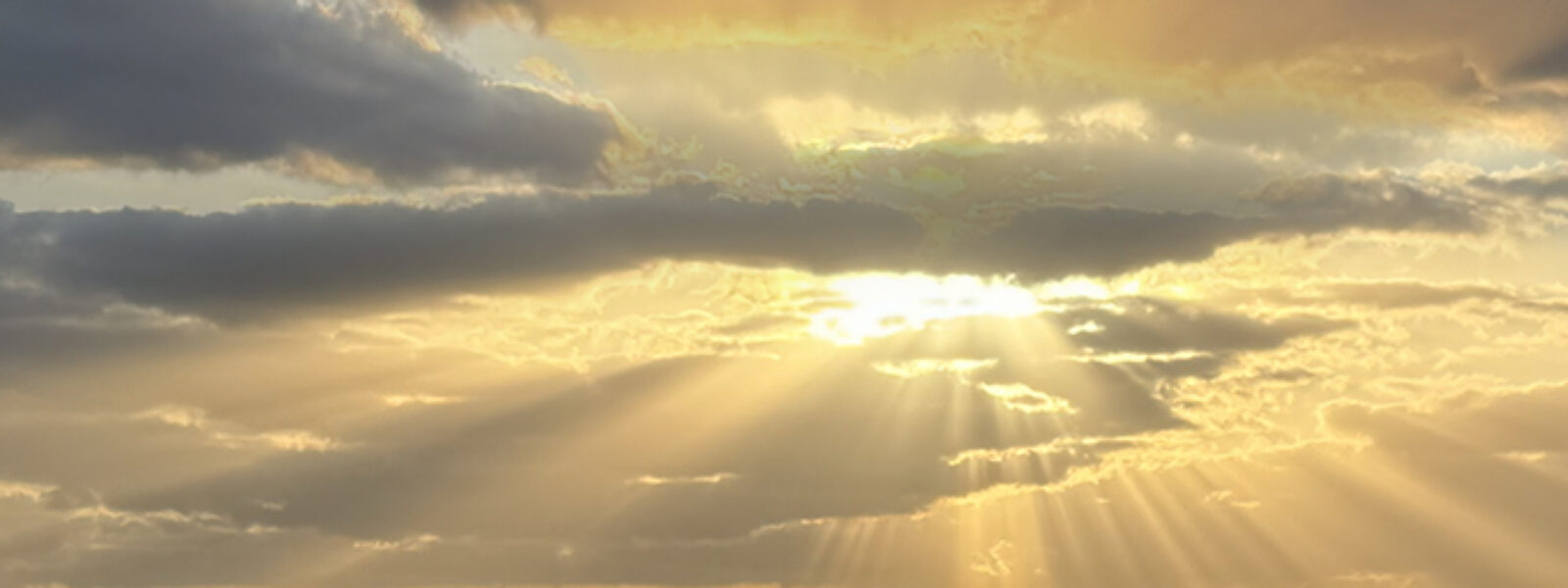 Sunbeams streaming through golden clouds